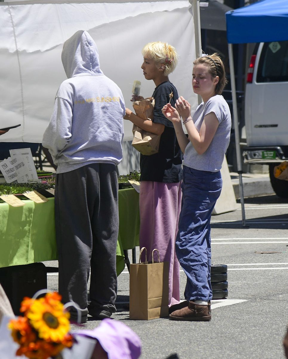 The sisters kept things effortlessly casual as they strolled through the market in comfortable, understated off-duty looks.
