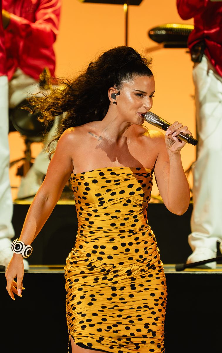Nathy Peluso embraced vintage-inspired glamour in a mustard yellow polka dot dress at the Hollywood Bowl.