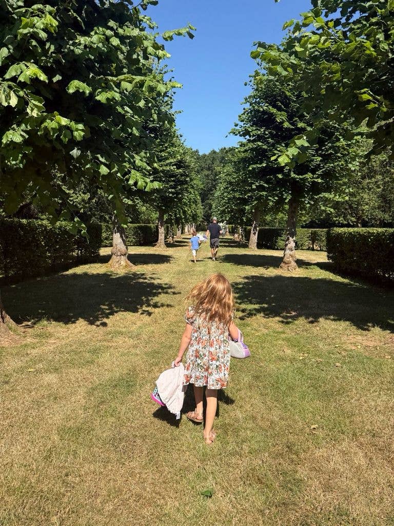 Princess Lilibet's flame-red hair was on display as she walked through the gardens