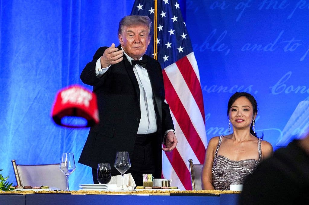 President Donald Trump tosses his TRUMP 2028 hat to an attendee during the re-scheduled White House Correspondents Dinner in the Presidential Ballroom at the Waldorf Astoria on July 24, 2026 in Washington, DC. The annual gala hosted by the White House Correspondents Association was re-scheduled to tonight after the original event in April was cut short when an armed man, later identified as Cole Tomas Allen, attempted to get past a Secret Service checkpoint. (Photo by Eric Lee/Getty Images)