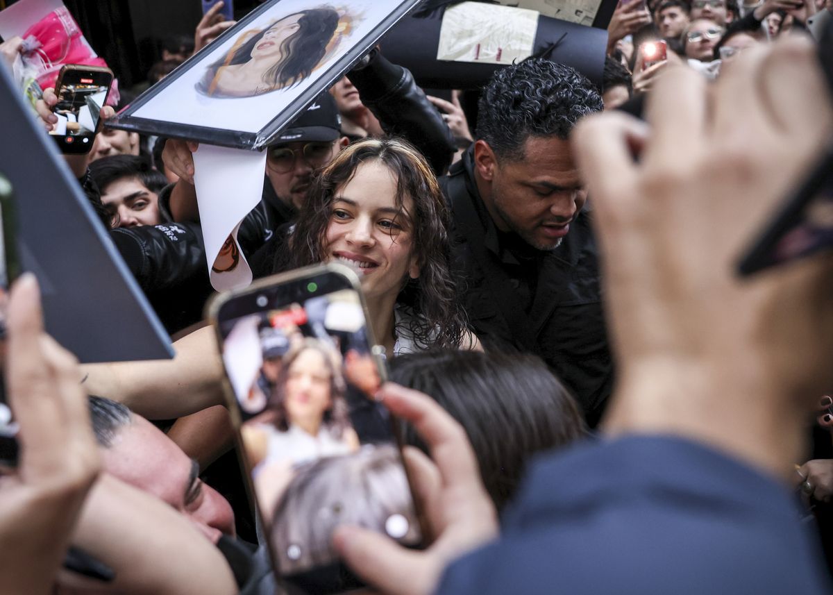 Rosalía smiles as she makes time to interact with fans before taking the stage in Santiago.