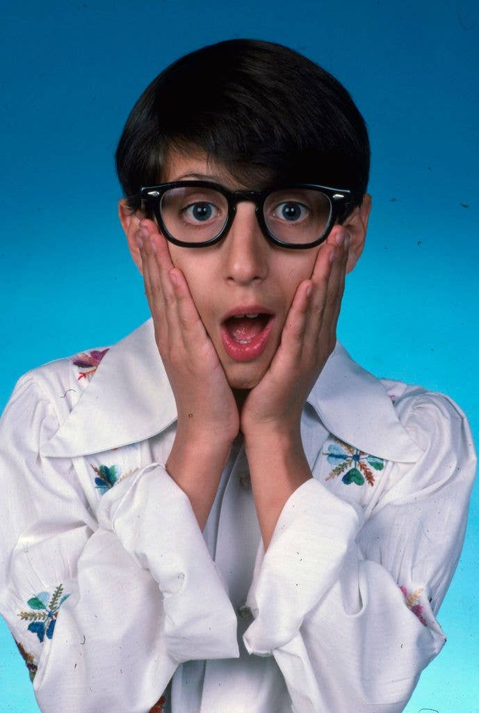 Josh Saviano pulling a shocked expression with a hand on both of his cheeks.