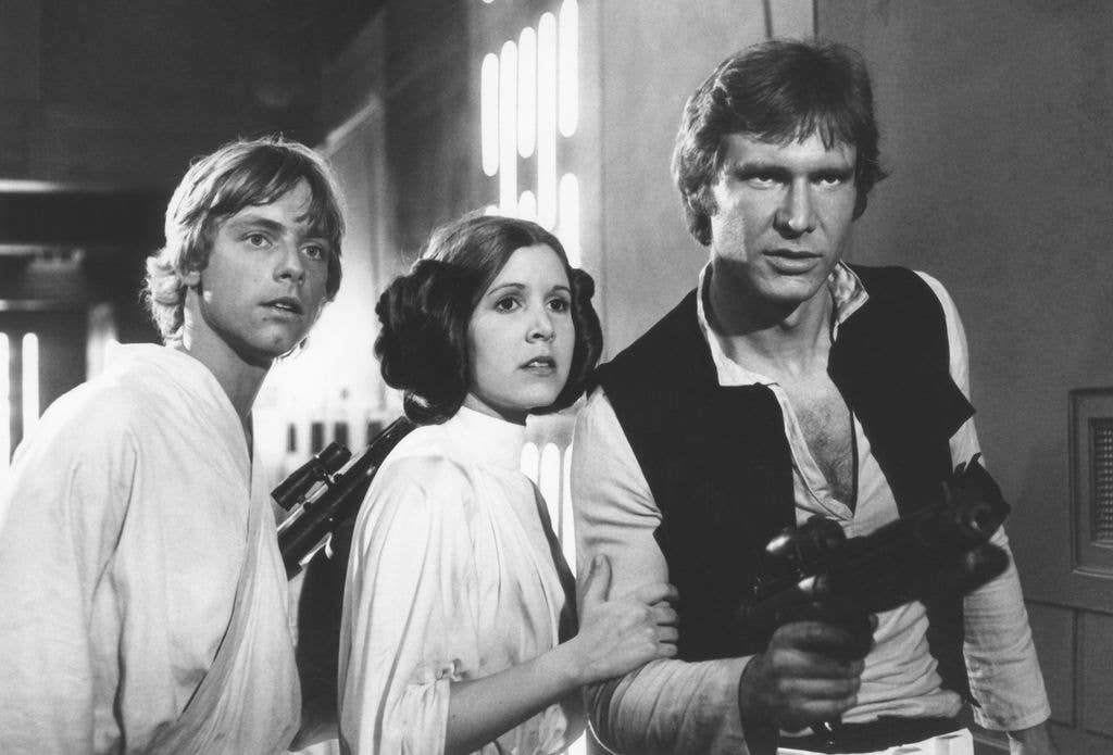Harrison Ford as Han Solo, Mark Hamill as Luke Skywalker and Carrie Fisher as Princess Leia in space ship in a scene from 'Star Wars A New Hope' 1977.
