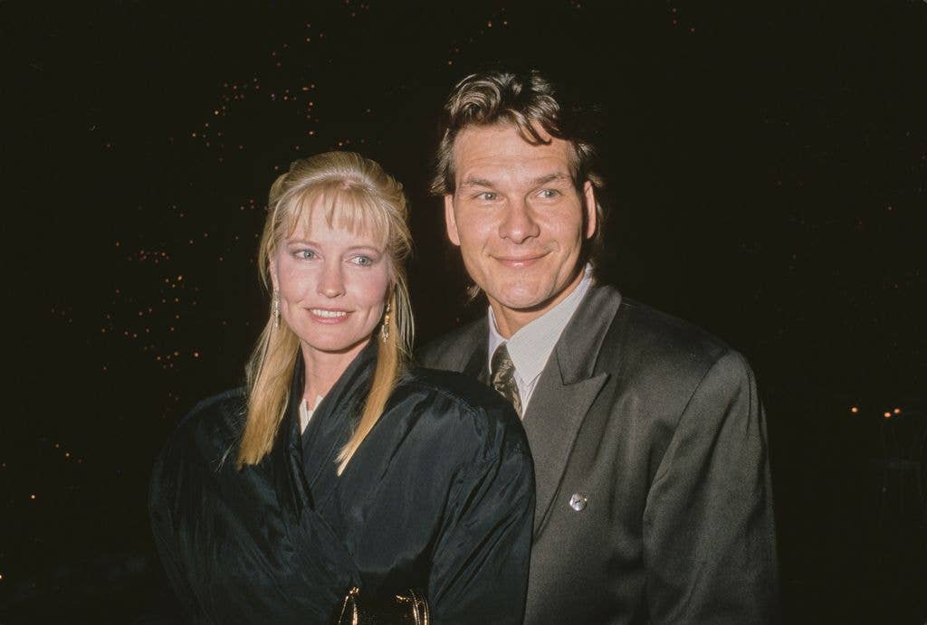 American dancer, choreographer and actress Lisa Niemi, wearing a black coat, with her husband, American actor, singer and dancer Patrick Swayze, who wears a dark grey suit jacket, attend Sandy Gallin's Christmas Party, held at Gallin's home in Beverly Hills, California, 18th December 1988. 
