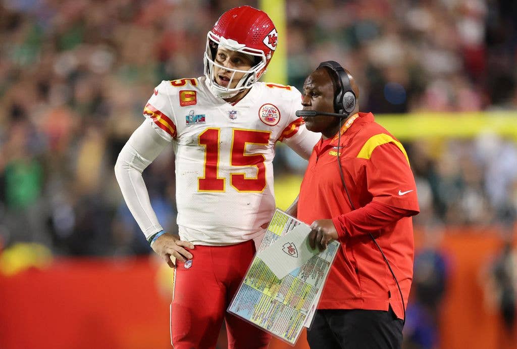 Patrick Mahomes #15 of the Kansas City Chiefs talks with offensive coordinator Eric Bieniemy during the fourth quarter against the Philadelphia Eagles in Super Bowl LVII at State Farm Stadium on February 12, 2023 in Glendale, Arizona
