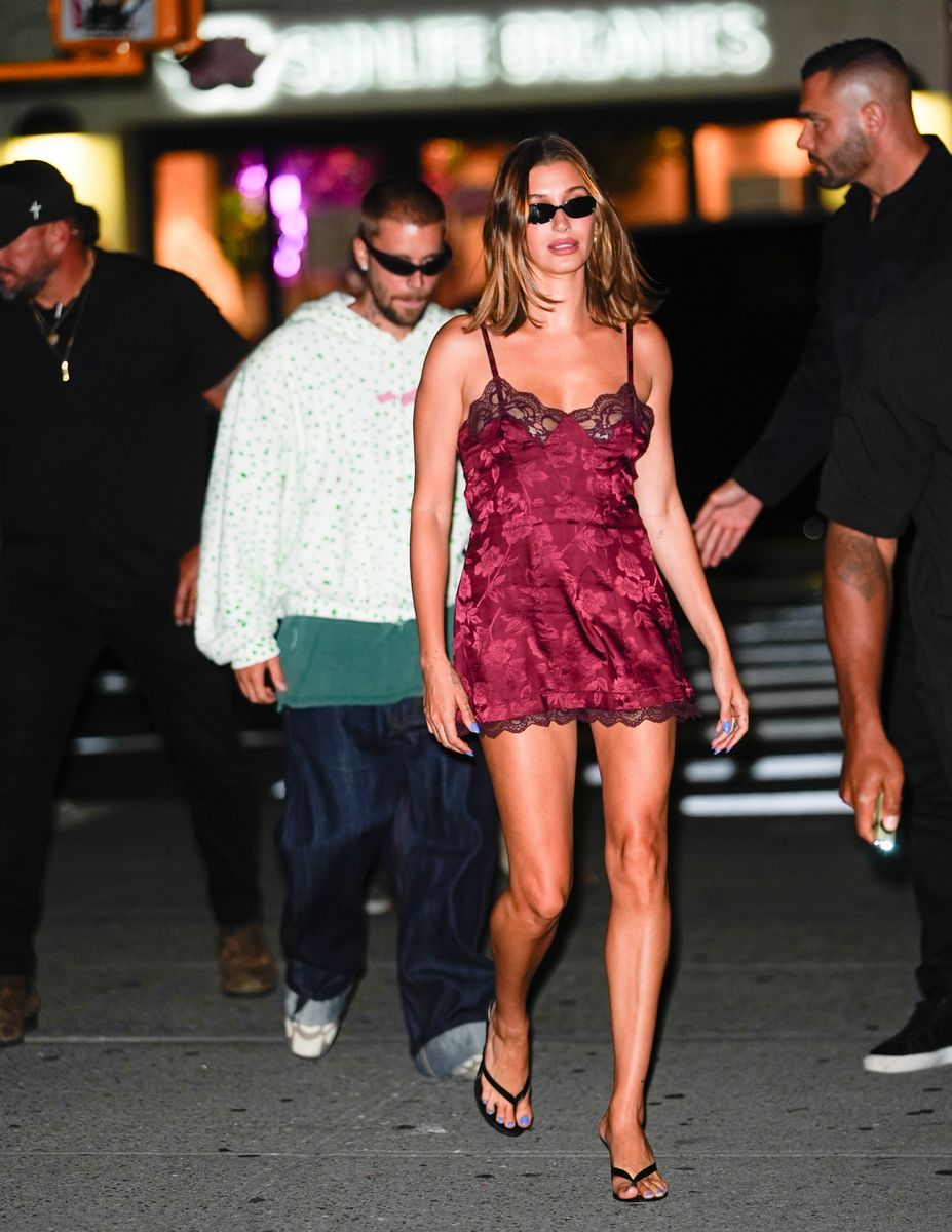 The model embraced the underwear-as-outerwear trend in a burgundy silk mini with delicate lace details and minimalist accessories.