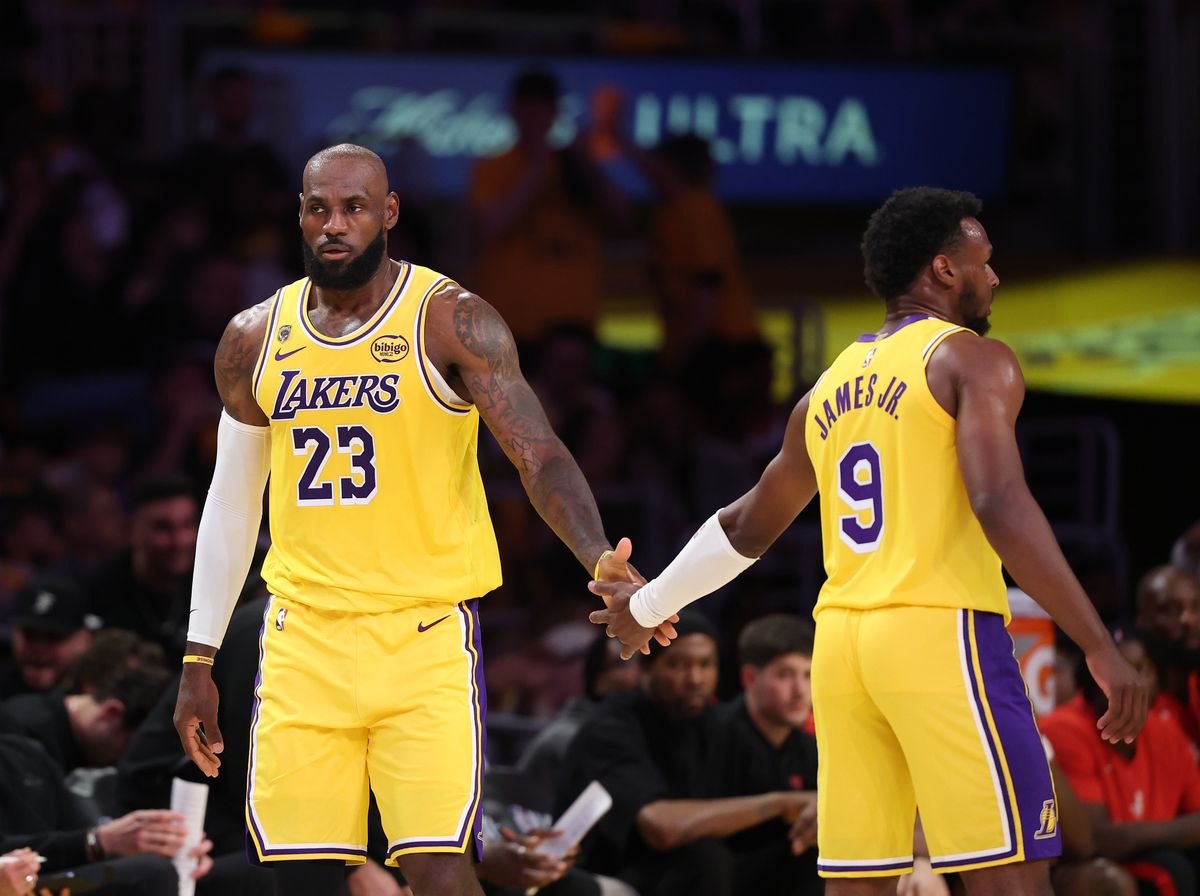 Lakers forward LeBron James, #23, left, is congratulate by his son and teammate Lakers guard Bronny James, #9 during Game 1 of their first-round playoff series against the Houston Rockets
