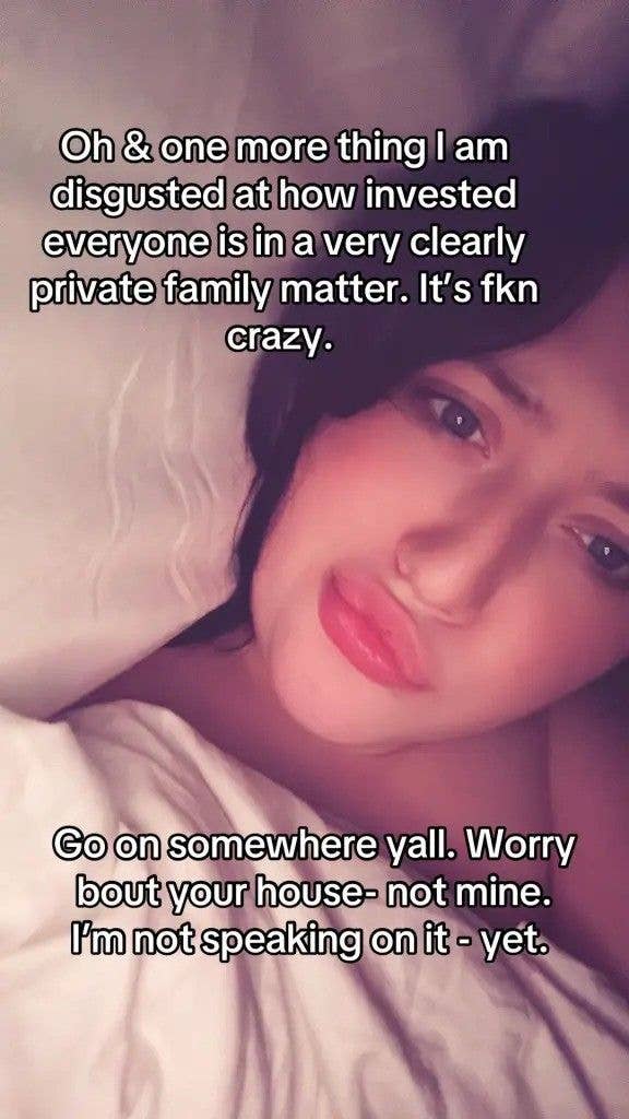 A woman with short hair lies on a bed with white sheets, looking directly at the camera with a slightly annoyed expression. Text overlay reads, 'Oh & one more thing I am disgusted at how invested everyone is in a very clearly private family matter. It’s fkn crazy. Go on somewhere yall. Worry bout your house- not mine. I’m not speaking on it - yet.'
