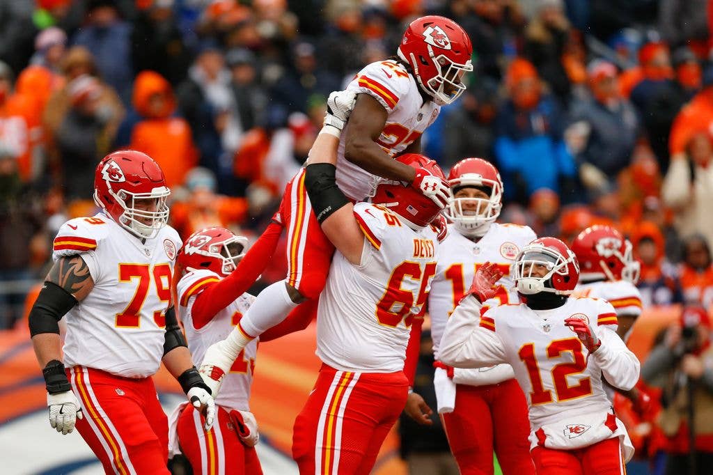Running back Kareem Hunt #27 of the Kansas City Chiefs celebrates his first-quarter touchdown with offensive tackle Jordan Devey #65, offensive guard Parker Ehinger #79, wide receiver De'Anthony Thomas #13, quarterback Patrick Mahomes #15 and wide receiver Albert Wilson #12 against the Denver Broncos at Sports Authority Field at Mile High on December 31, 2017 in Denver, Colorado. (Photo by Justin Edmonds/Getty Images)