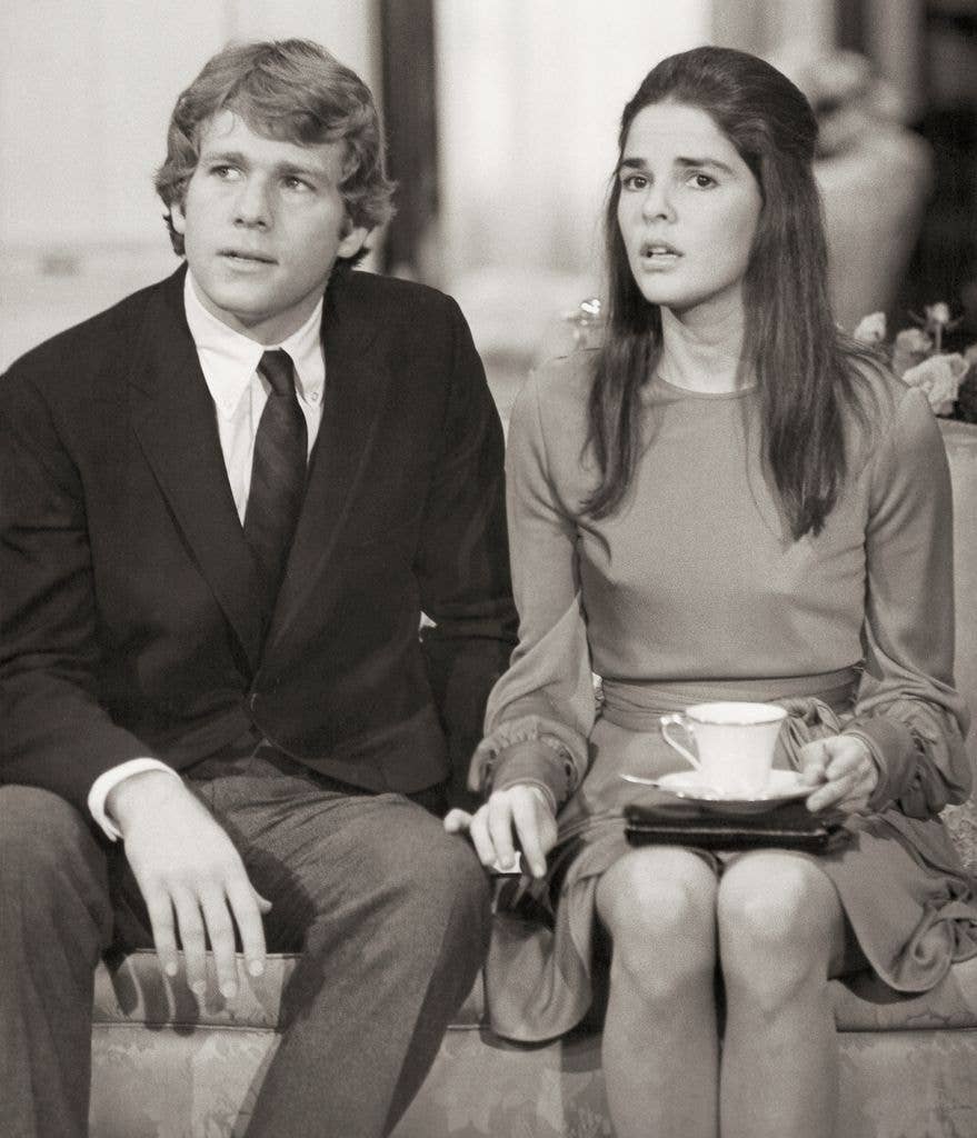 Ryan O'Neal and Ali MacGraw looking worried in a scene from the 1970 Paramount film, Love Story, in which they star as ill-fated lovers.