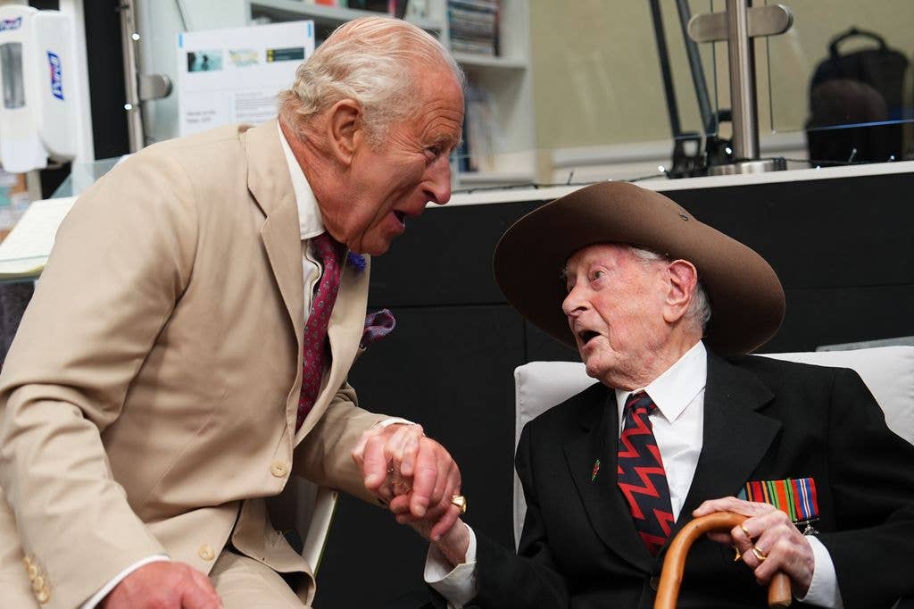 King Charles speaking with a war veteran