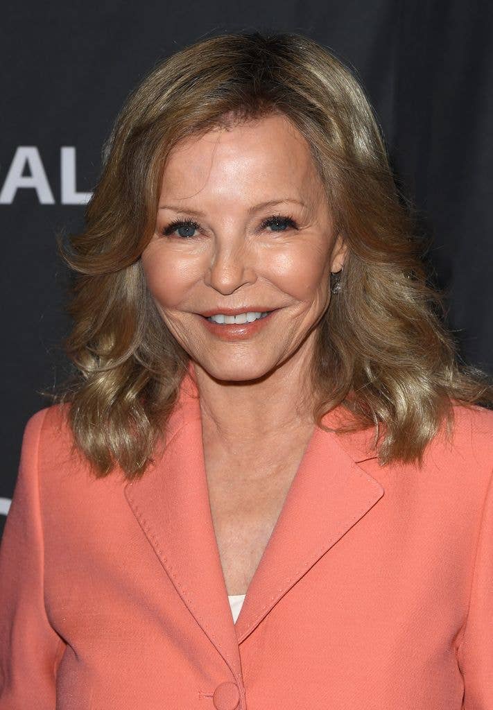 Cheryl Ladd in a peach jacket with a long blonde bob smiling straight at the camera.