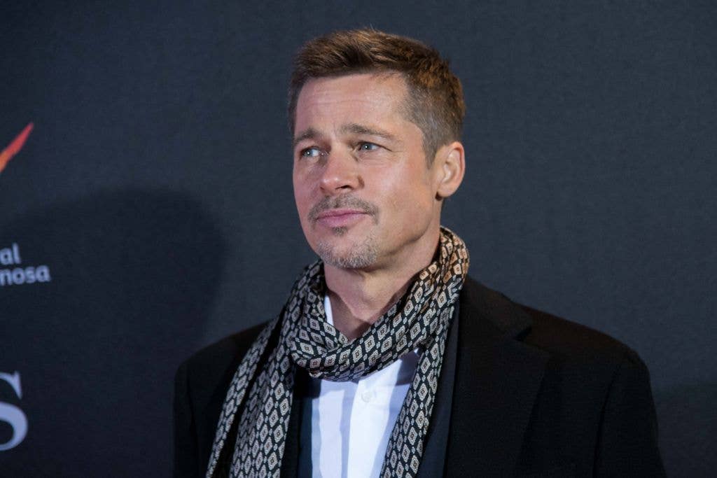 Brad Pitt at the premiere of Allied in a shirt, jacket and scarf.