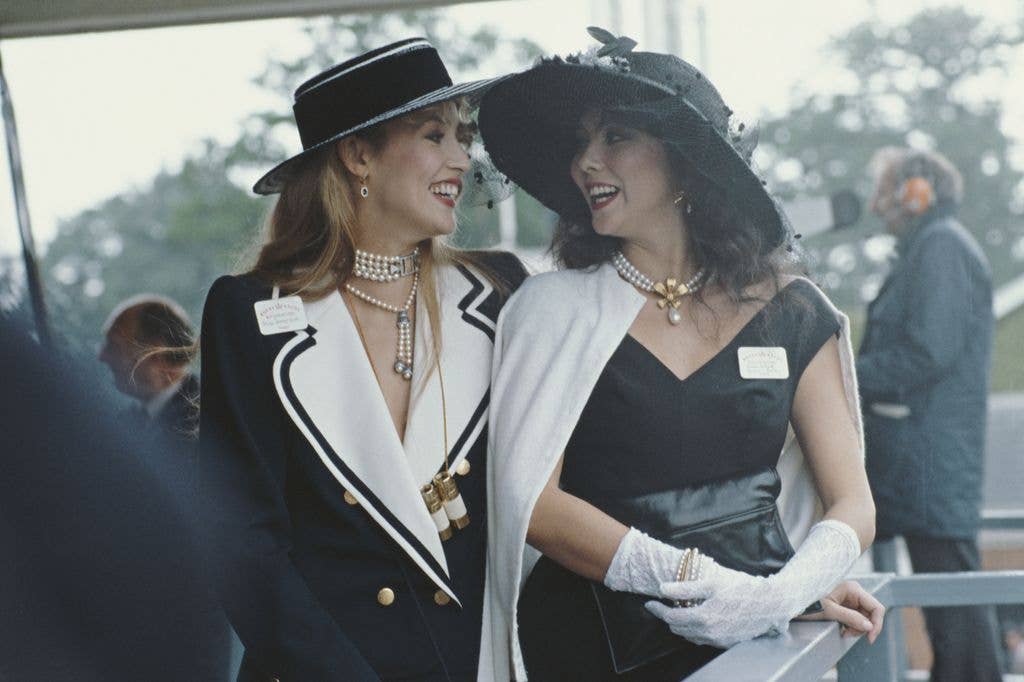 Models Jerry Hall (left) and Marie Helvin at Royal Ascot in Berkshire, UK, 1982.