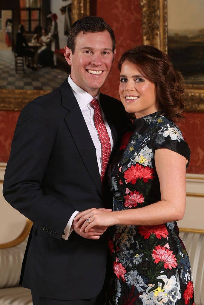 Princess Eugenie and Jack Brooksbank smiling, standing close together in a formal setting.