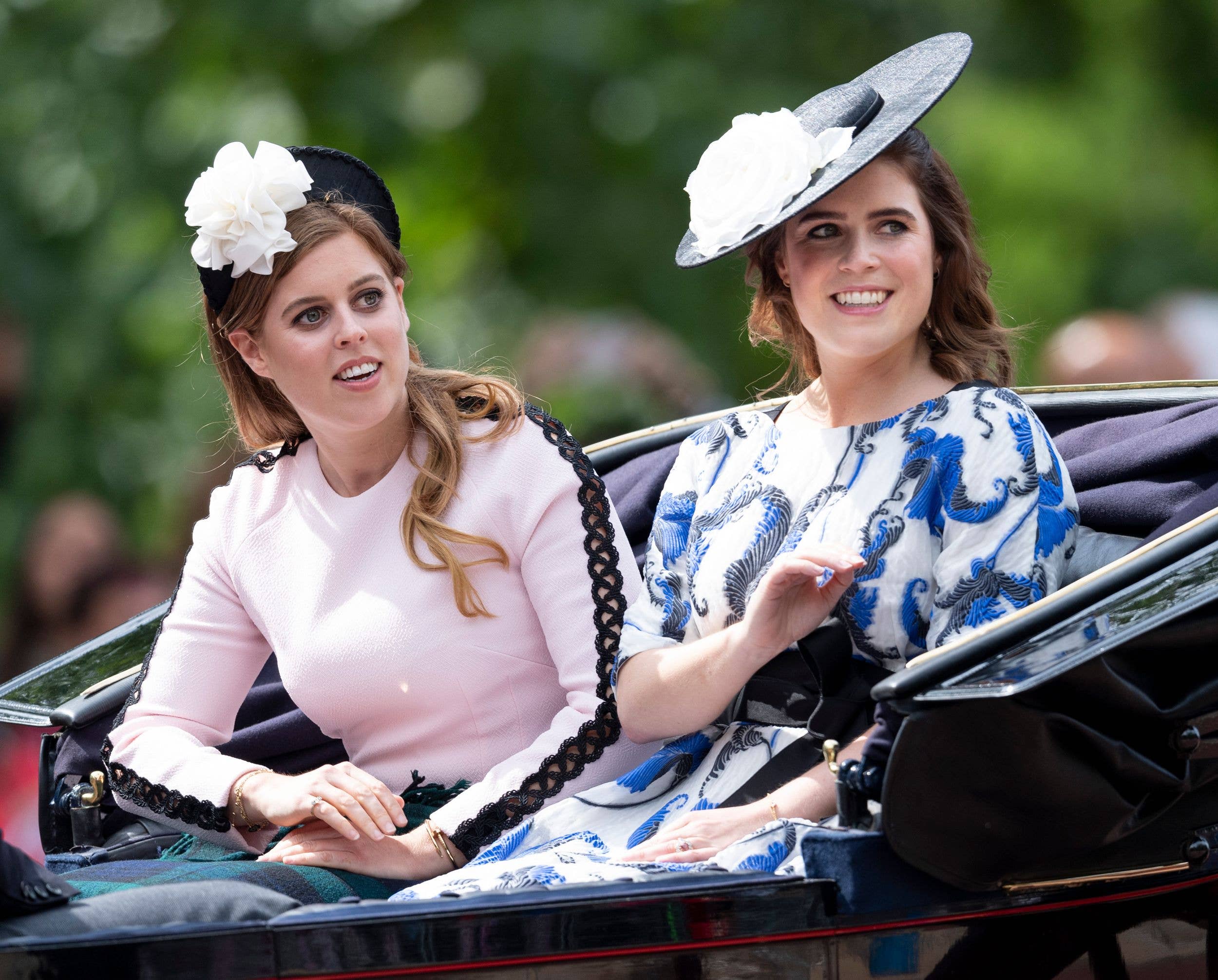 Pricess Beatrice and Princess Eugenie riding in a carriage