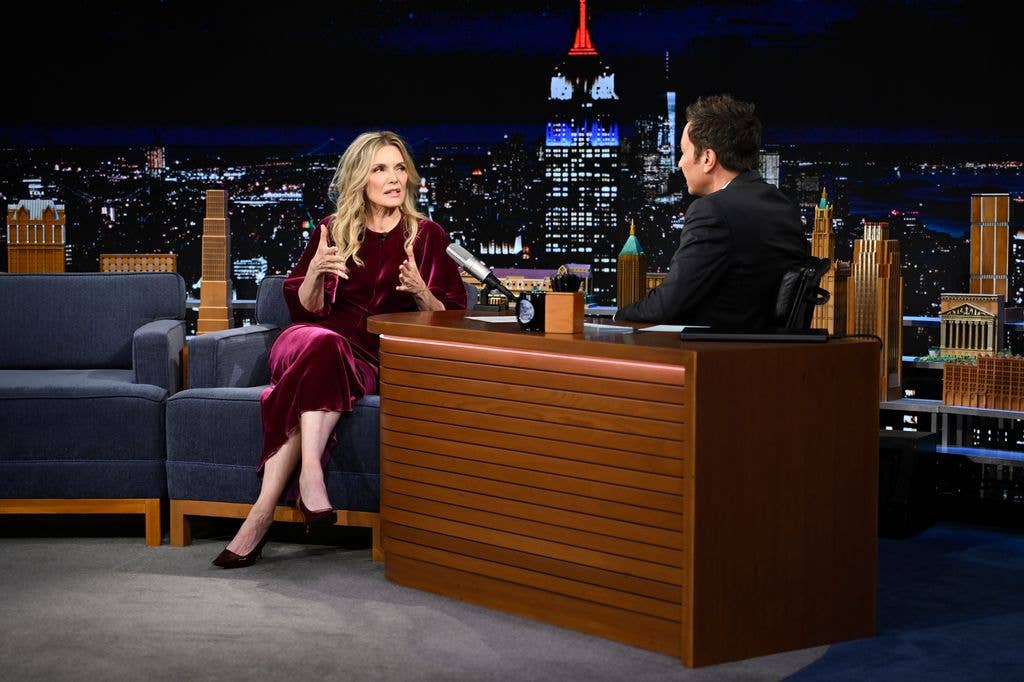 Michelle Pfeiffer sitting on a couch talking to Jimmy Fallom
