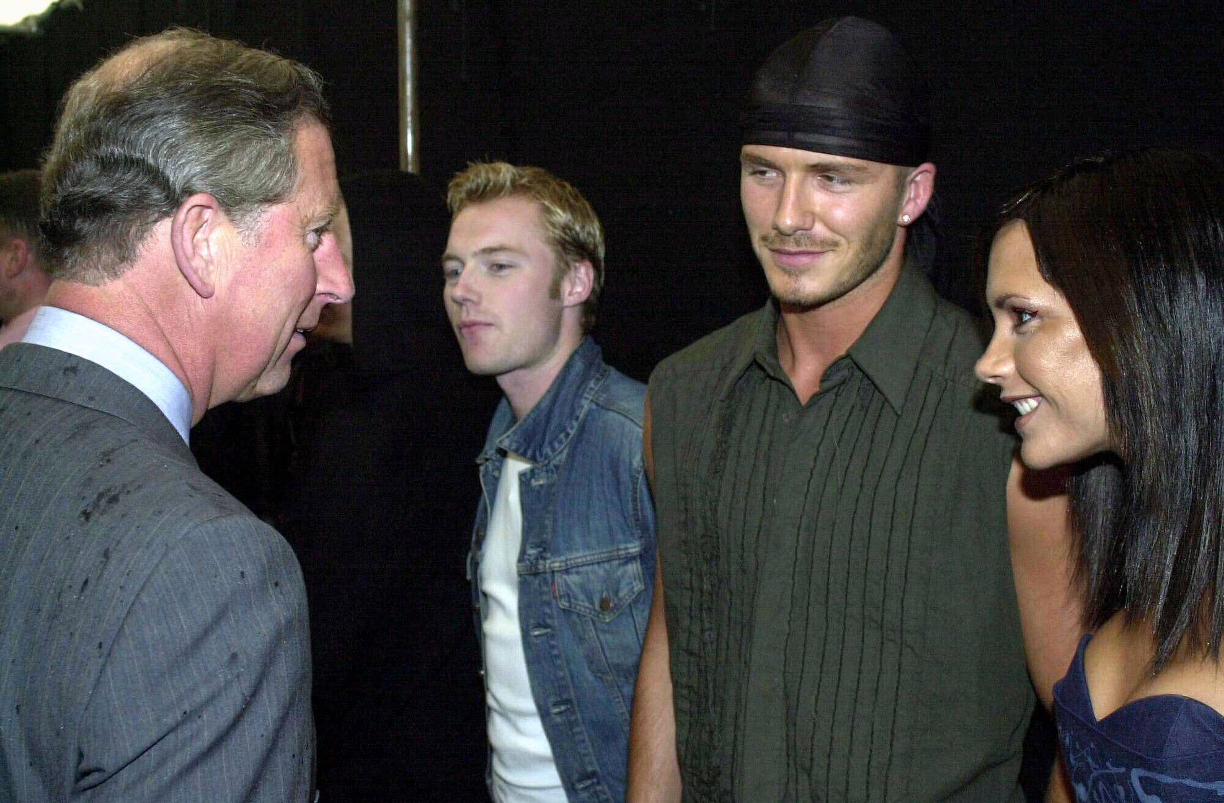 King Charles talking to Victoria Beckham and David Beckham