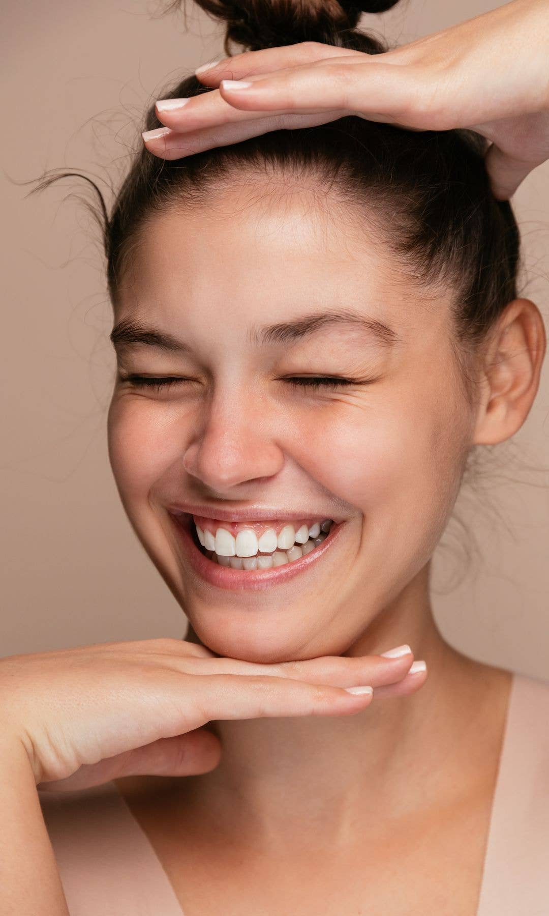 Model with beautiful skin closing her eyes and smiling