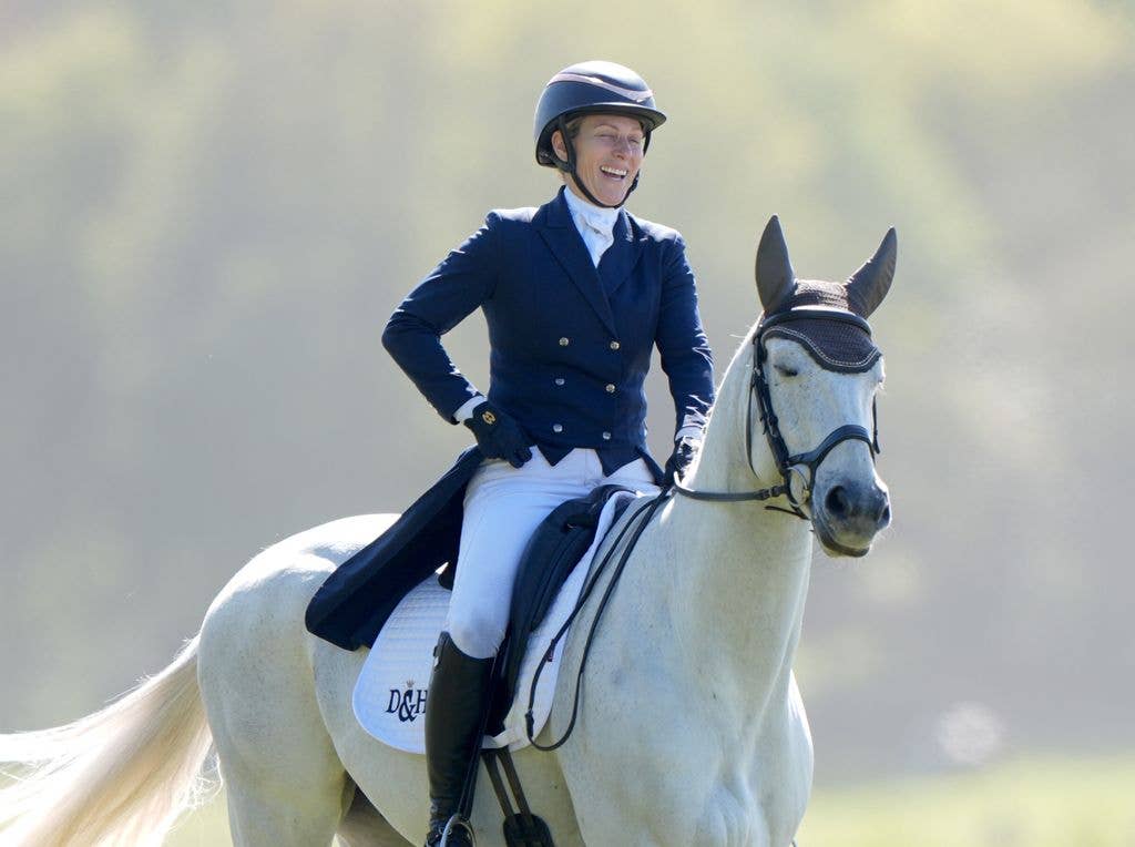 Zara Tindall on her horse laughing wearing helmet