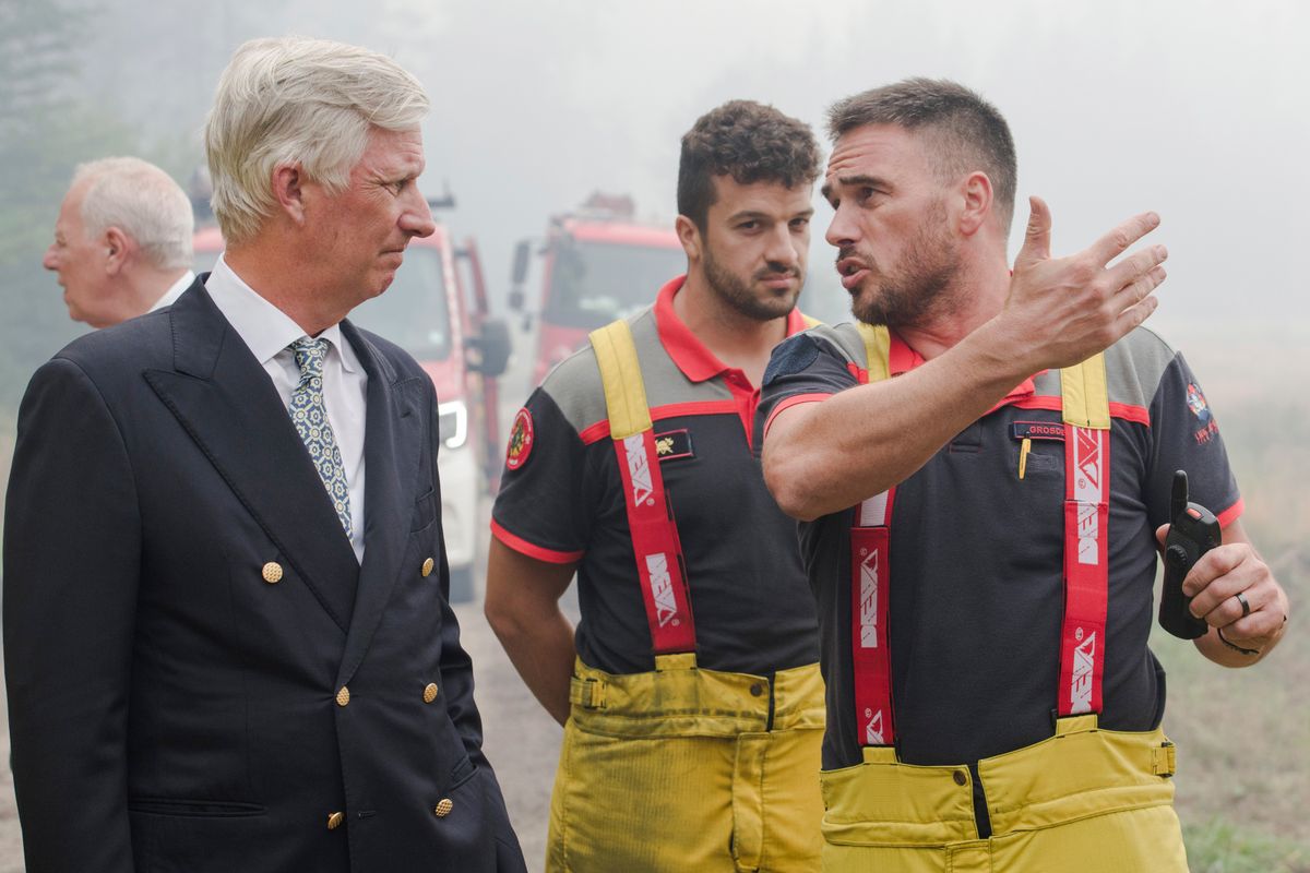 The Belgian monarch met firefighters and emergency personnel working to bring the devastating fires under control.