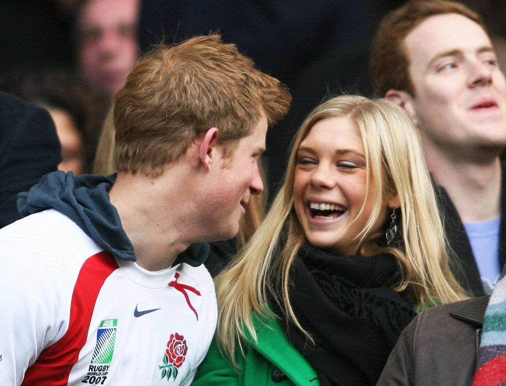 Prince Harry and Chelsy Davy laughing during a rugby match