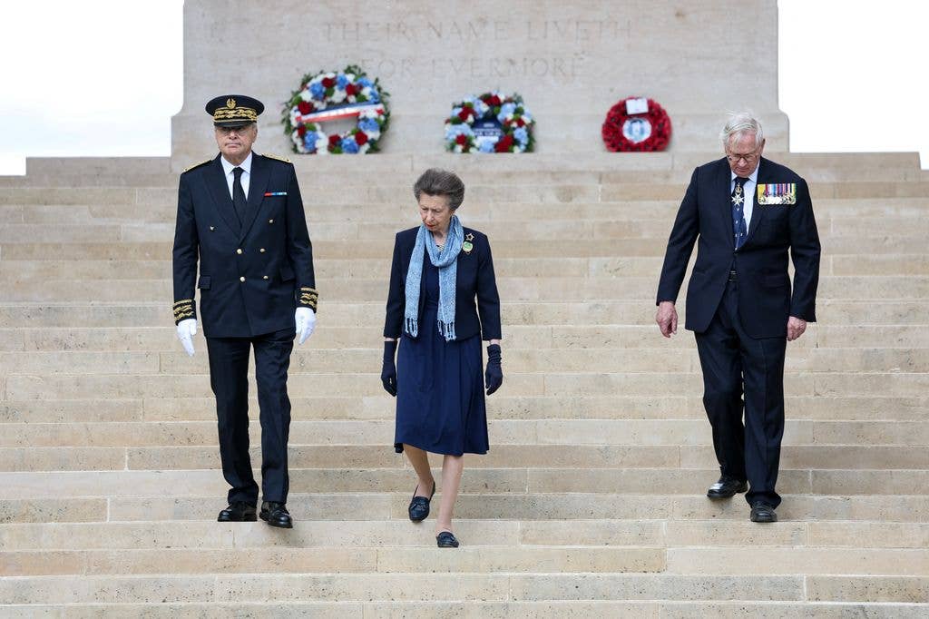 Princess Anne and the DUke of Gloucester walking down a set of stairs
