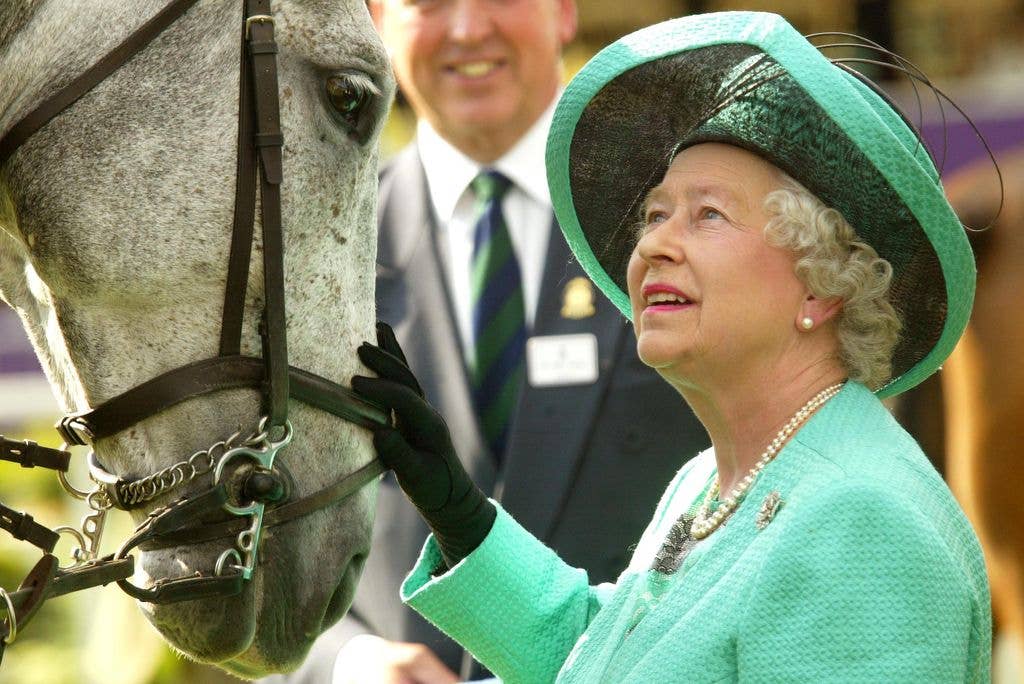 Queen Elizabeth II petting a horse