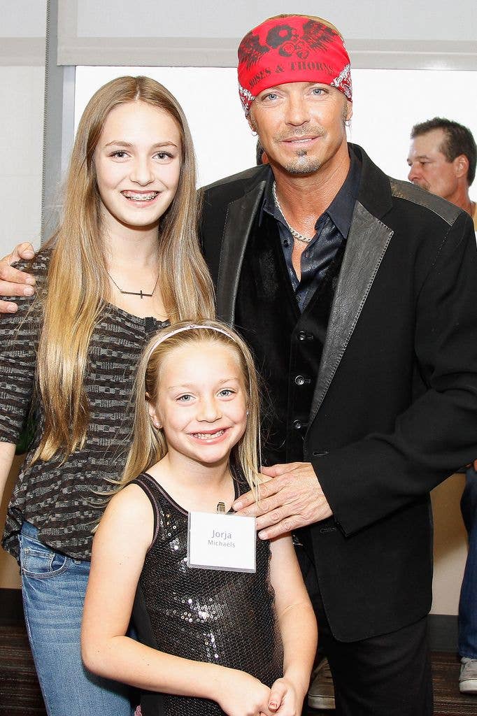 Musician Bret Michaels poses with daughters Raine Sychak (L) and Jorja Sychak (C) during the ribbon cutting ceremony for the new Bret Michael's Hospitality and Music Room at St. Joseph's Barrow Neurological Institute on October 9, 2012 in Phoenix, Arizona