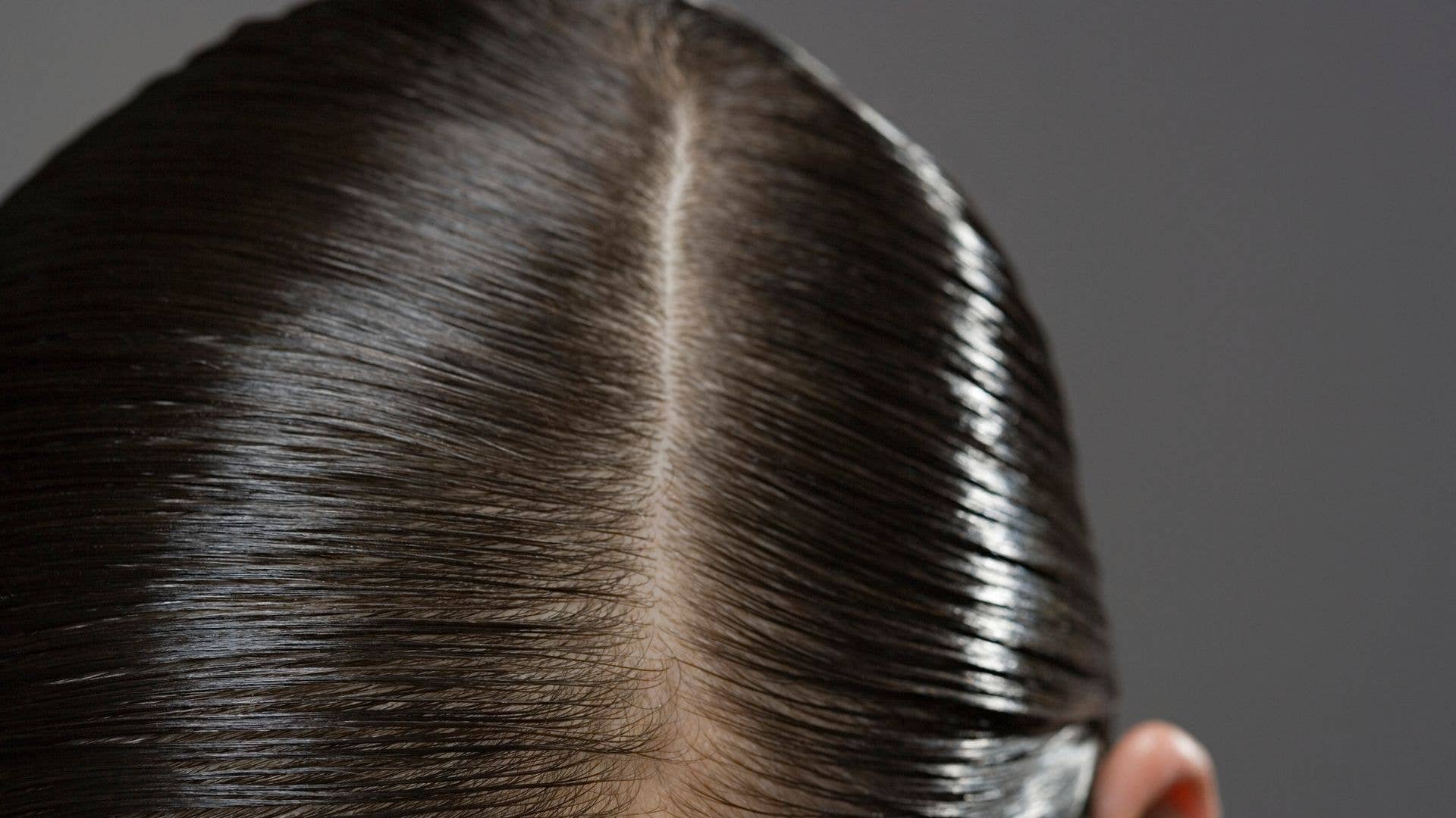 Close up of gelled hair with a side parting