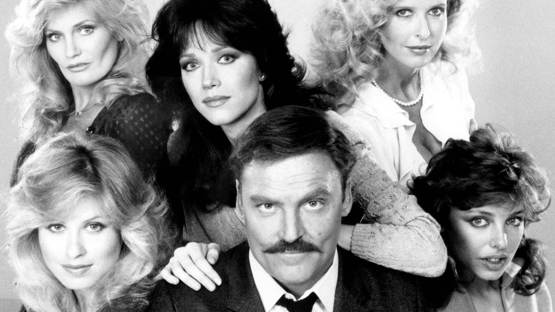 Black and white photo of six women and one man, including Tanya Roberts and Stacy Keach.