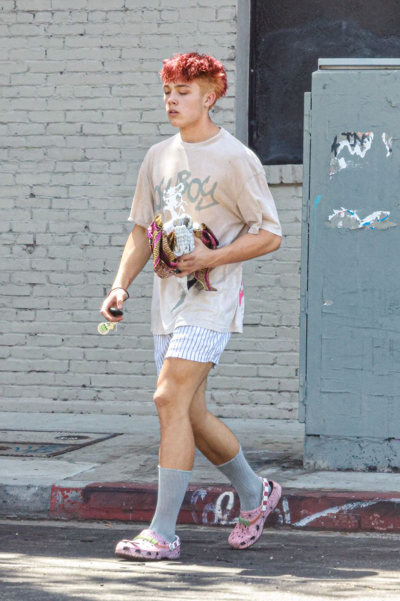 Knox added a playful touch to his post-workout look with pink floral Crocs and tall gray socks.