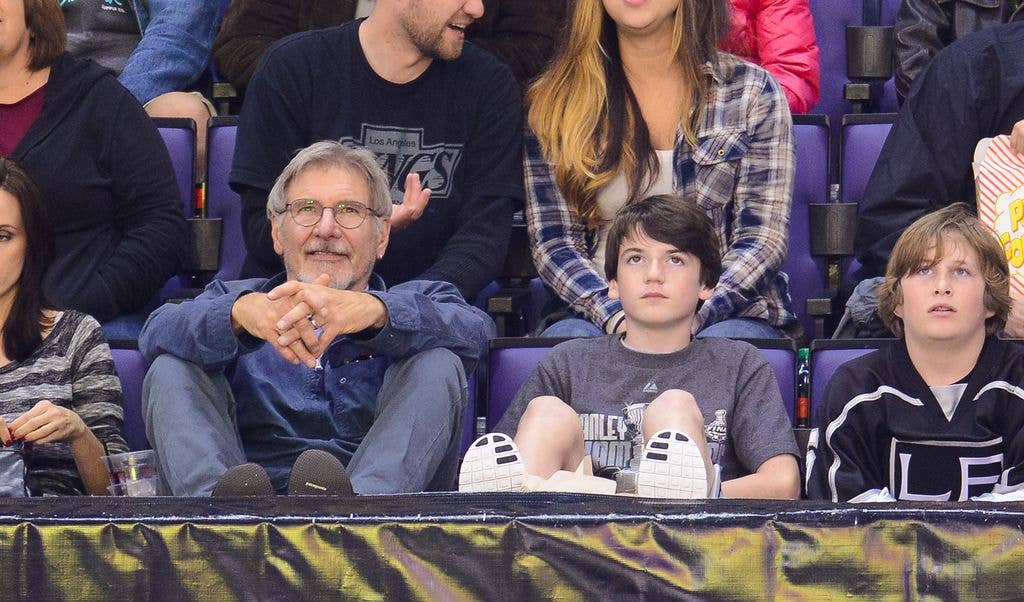 Harrison Ford (L) and Liam Flockhart attend a hockey game between the Carolina Hurricanes and the Los Angeles Kings at Staples Center on March 1, 2014 in Los Angeles, California. 