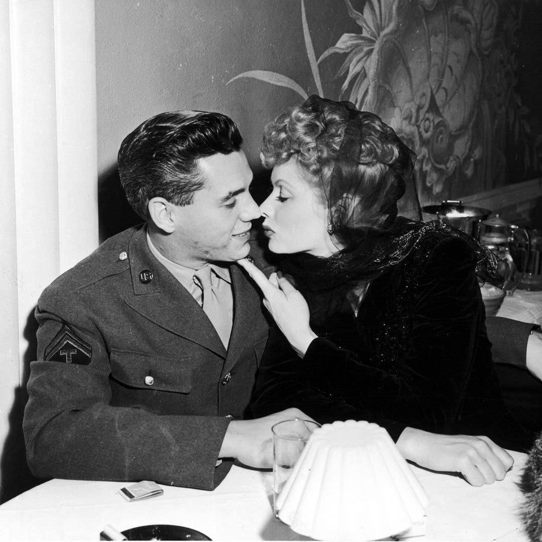 American actress Lucille Ball (1911 - 1989) with her husband Desi Arnaz (1917 - 1986), circa 1944. Desi is wearing the sleeve insignia of a Technician Fifth Grade of the US Army, having been drafted during World War II.