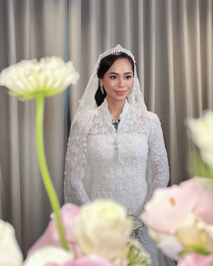 Princess Ilyana makes her entrance in an exquisite couture gown by Datuk Radzuan Radziwill, accompanied by members of the Pahang royal family.