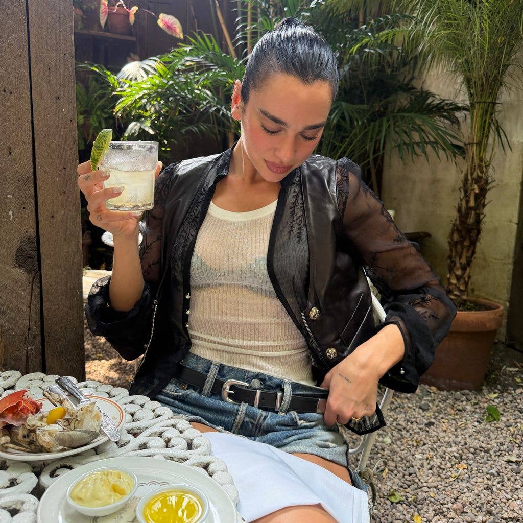 Dua Lipa in white top and denim shorts