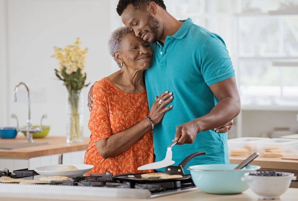 son taking care of elderly mother