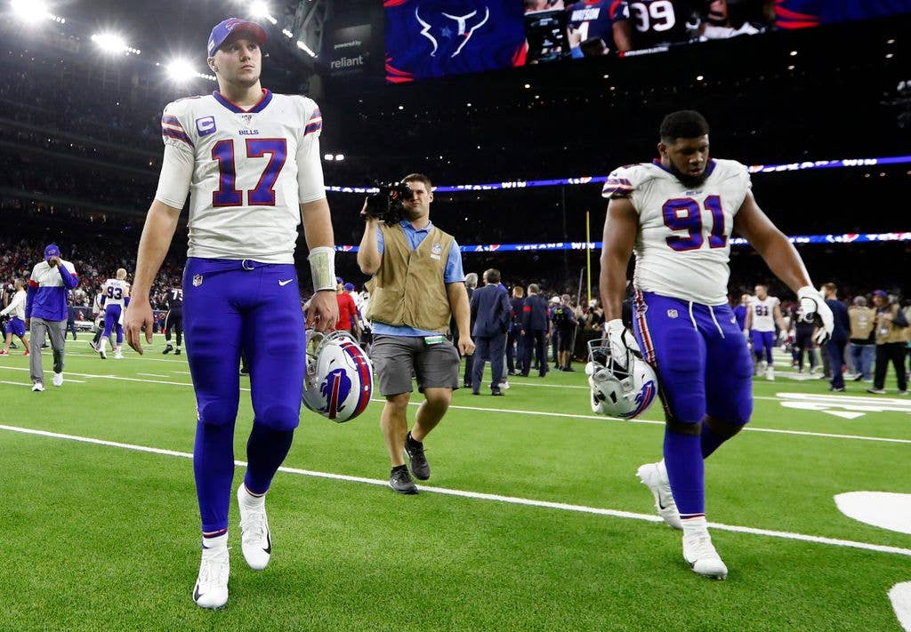 Josh Allen #17 of the Buffalo Bills and Ed Oliver #91 walk off the field after the 22-19 overtime loss to the Houston Texans in the AFC Wild Card Playoff game at NRG Stadium on January 04, 2020 in Houston, Texas