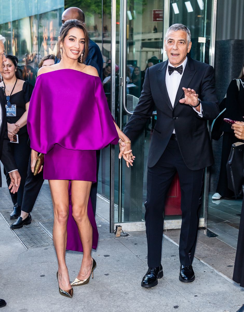 Amal Clooney puts a chic spin on the mini dress, showing off her legs in a bold purple look and gold pumps