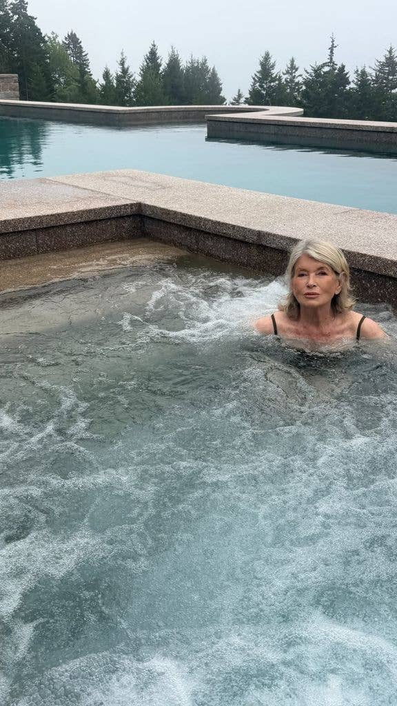 Martha Stewart poses for a photo in the new hot tub of her Bedford, New York home, shared on her Instagram Stories on her 85th birthday