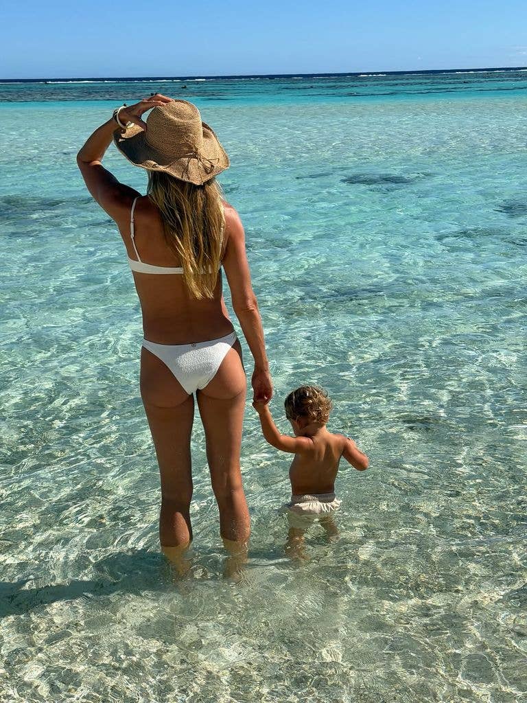 Gisele enjoyed the beach views with bub in hand