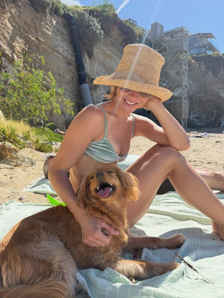 Julianne Hough poses with her dog on a beach