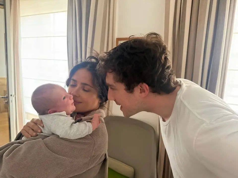 Salma cuddling the newborn while his proud father looked on