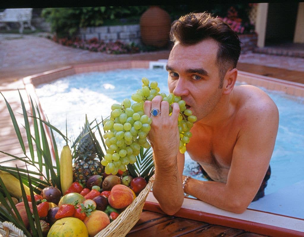 Morrissey, singer, song writer and author enjoys a snack of fruit in his jacuzzi tub in Beverly Hills, California in August 1992