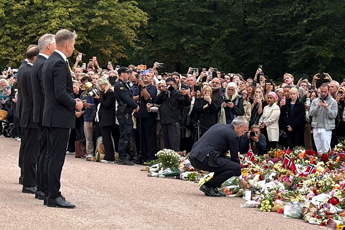 Norwegian Prime Minister Jonas Gahr Støre lays a flower in honor of King Harald V in front of the Royal Palace in Oslo.