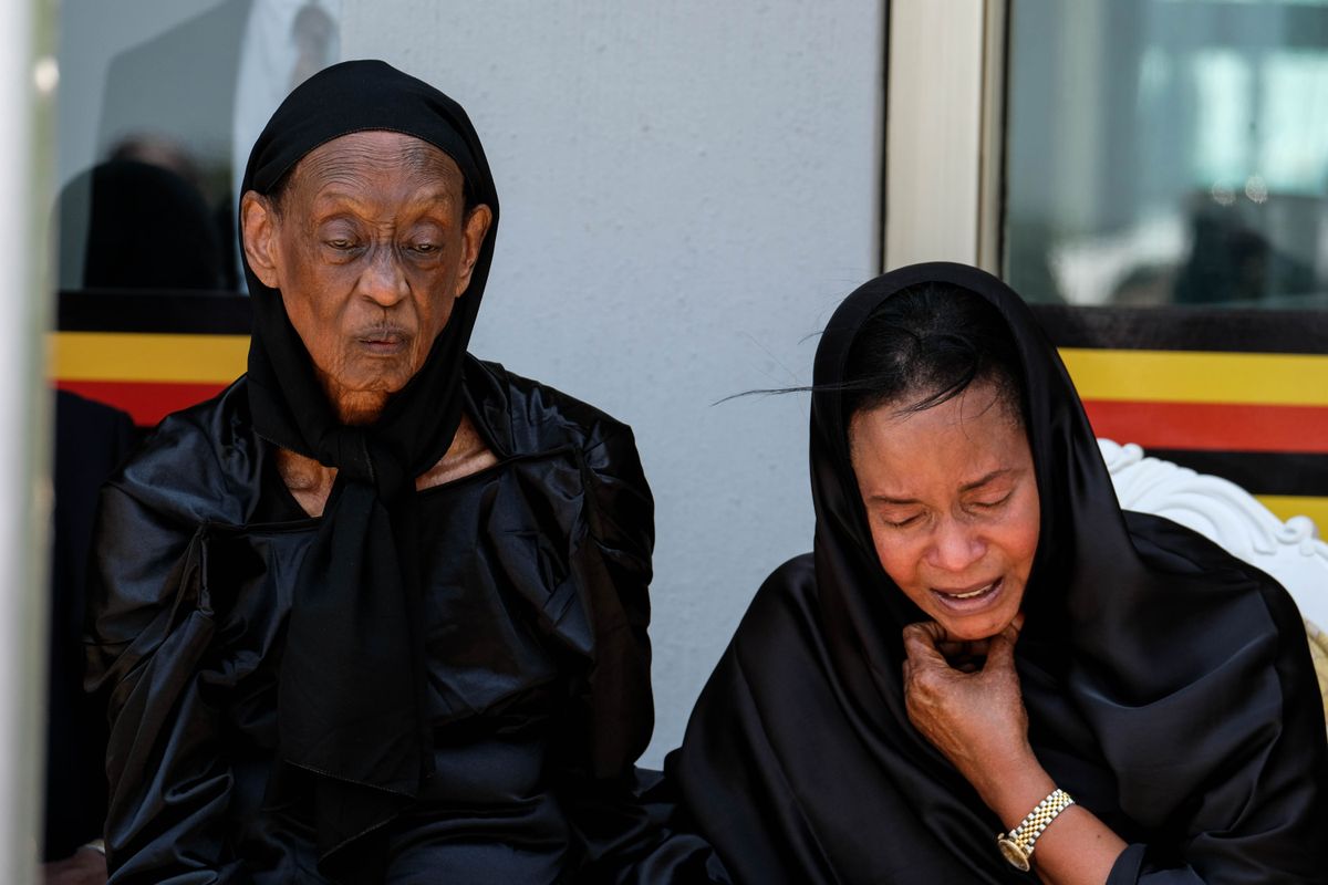Queen Mother Best Kemigisa and Princess Elizabeth Bagaya stand together in tears as they await the arrival of King Oyo Rukidi IV’s coffin.