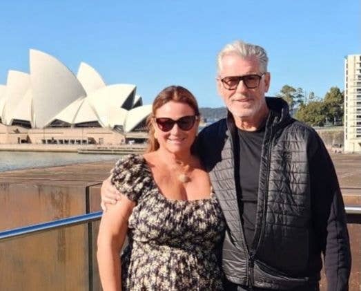 Pierce Brosnan and his wife Keely Shaye Brosnan pose for a photo in front of the Sydney Opera House, shared on Instagram