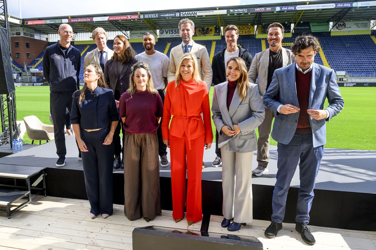 Máxima stood out in a vibrant orange-red ensemble as she arrived at the soccer stadium in Breda.
