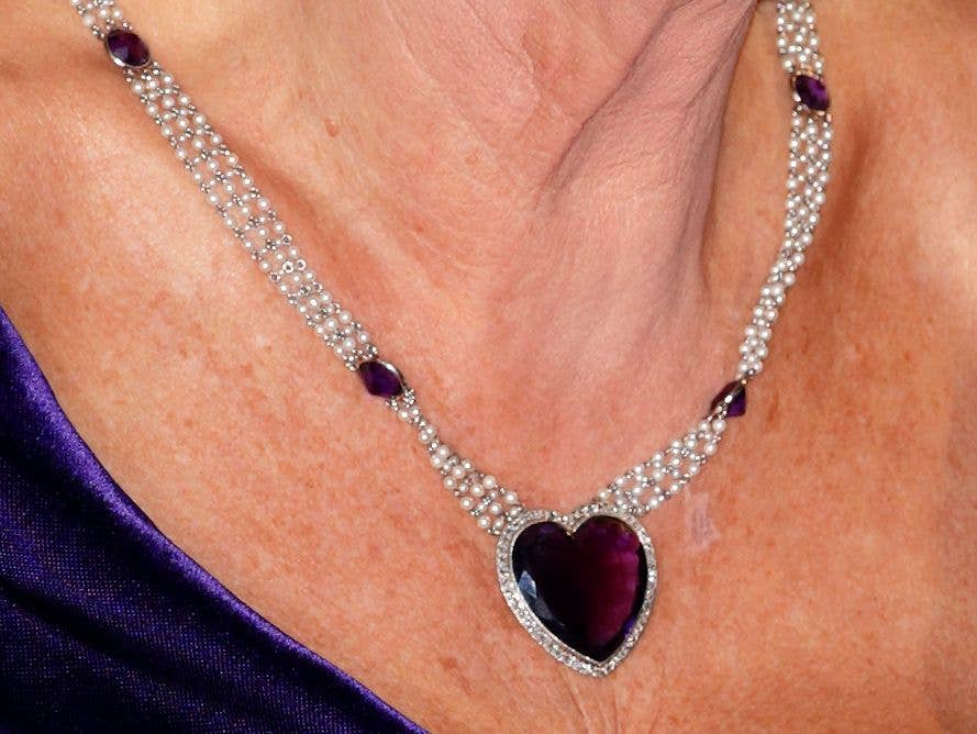 Camilla, Duchess of Cornwall wears a purple heart shaped pendant necklace as she attends the Royal World Premiere of 'Skyfall' at Royal Albert Hall on October 23, 2012 in London, England