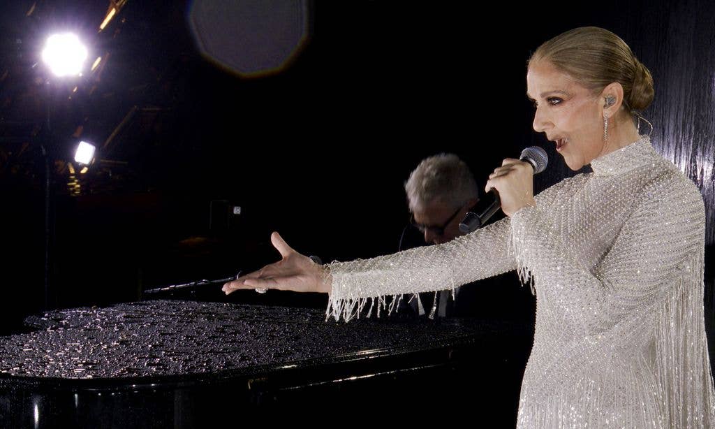 Celine Dion singing in a silver dress